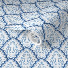 a blue and white wallpaper with an intricate design on it's surface,