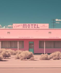 a pink motel sitting on the side of a road