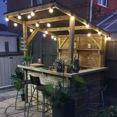 an outdoor bar is lit up with lights