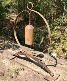 an old fire extinguisher sitting on top of a wooden table in the woods