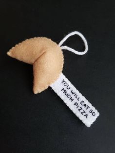 an ornament that says you'll eat pizza on it and is made out of felt