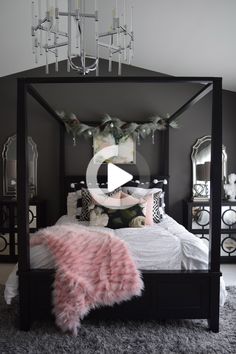 a black and white bedroom with pink fur rugs on the floor, chandelier above the bed