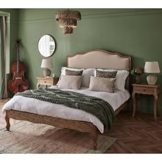 a bedroom with green walls and wooden furniture