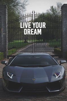 a car parked in front of a gate with the words live your dream on it