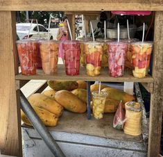 there are many cups with fruit in them on the truck bed, and one is filled with watermelon