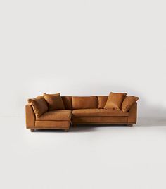 a brown couch sitting on top of a white floor