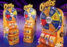 two vending machines with chips and cheeses on them in front of a stage