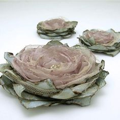 three pieces of fabric with flowers sitting on top of each other in front of a white background