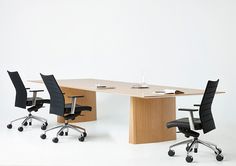 an office desk with two chairs and a table