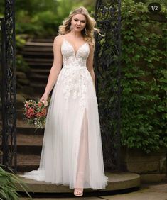 a woman in a wedding dress standing on steps