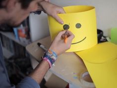 a man is making a paper hat out of construction material