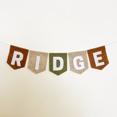 a banner that says ridge hanging on a string