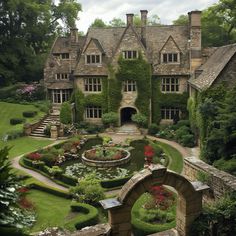 a large house with lots of plants and flowers in the front yard, surrounded by greenery