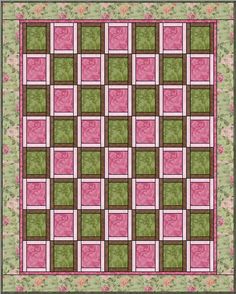 a pink and green quilt with squares on it