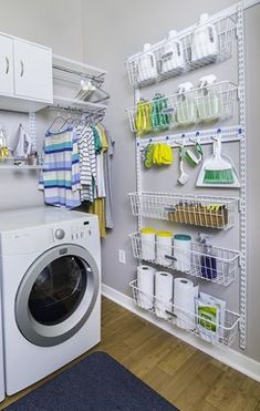 a washer and dryer in a laundry room with shelves on the wall behind them