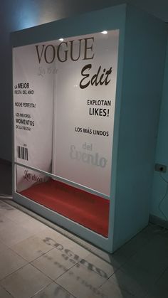 a display case with an advertisement on the front and back wall in a room filled with tile flooring