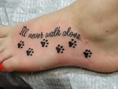 a person with a foot tattoo that says, i'll never walk donee