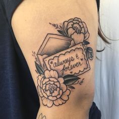 a woman with a tattoo on her arm that reads always & forever and has flowers around it