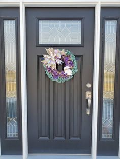 a front door with a wreath on it