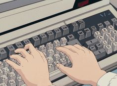 someone typing on an old fashioned computer with their hands resting on the keys and keyboard