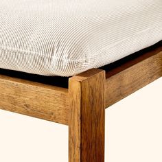 a close up of a wooden bed frame with a mattress on it's side