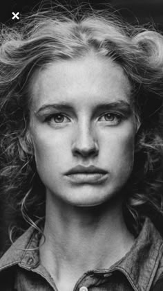 a black and white photo of a woman with blonde hair, wearing a denim shirt