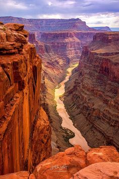 the grand canyon is surrounded by red rocks and green water in the river below it