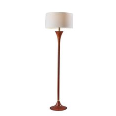 a floor lamp with a white shade on the base and a brown wooden pole in front of it