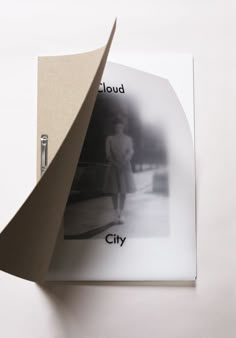 an open book with black and white photos on the cover, which reads cloud city