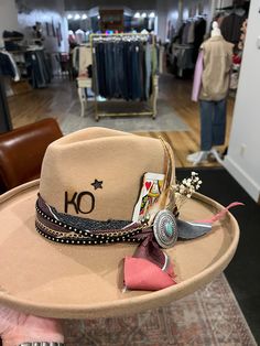 Can't make it to a Hat Bar pop-up or into our store to build a custom hat at our Hat Bar? No problem! Join us for a 1 hour session to create the hat you've been dreaming of. If you'd like to mail me items you'd like included in your custom hat build please mail them to me at 141 S Main Street, Stoddard, WI 54658 at least a week prior to your virtual session. You are responsible for shipping items and your finished hat to you. Included: 1 hour with stylist over FaceTime, all materials and brandin Embellished Cowgirl Hat, Make Your Own Cowgirl Hat, Custom Hat Ideas For Women, Custom Brim Hats, Hat Bar Display, Hat Bar Accessories, How To Make A Hat Band, Painted Cowboy Hats Diy, Diy Hat Bar Party