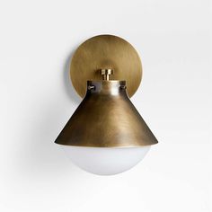 a brass wall light on a white wall