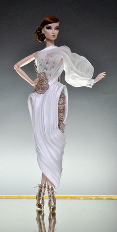 a barbie doll wearing a white dress and high heels with her hands on her hips