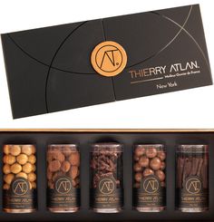 there are four jars with nuts in them next to a card that says therapy atlas