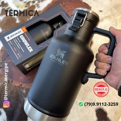 thermos is being held up in front of a cow skin background with an ad for tempicaa