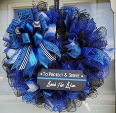 a blue and black mesh wreath that says protect & serve back the blue