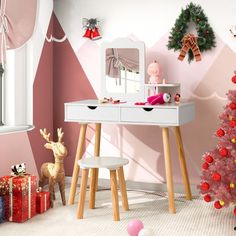 there is a desk with a mirror on it and christmas decorations in the room behind it