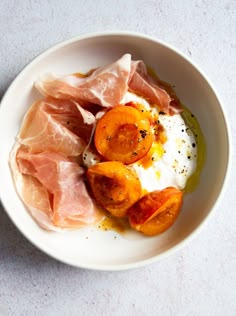 a white bowl filled with food on top of a table