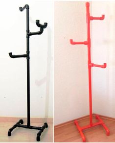 there are two different types of coat racks on the floor, one is red and the other is black