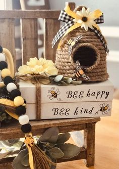 a wooden bench topped with a birdhouse and beehive