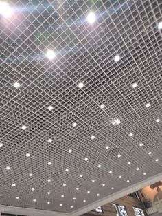 the ceiling is covered with white lights