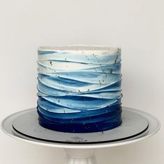 a blue and white cake sitting on top of a plate