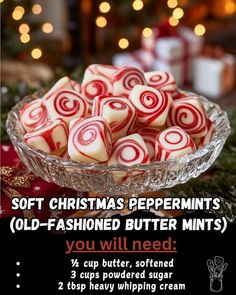 a glass bowl filled with peppermints on top of a table next to christmas decorations