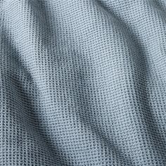 a close up view of a blue knitted material