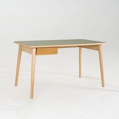 a wooden table with a drawer underneath it on a white background in an empty room