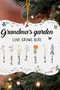 an ornament hanging from a christmas tree that says grandma's garden love grows here