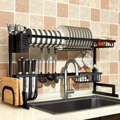 a kitchen sink and rack with utensils on it