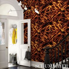 an entry way with a wallpapered pattern and coat rack