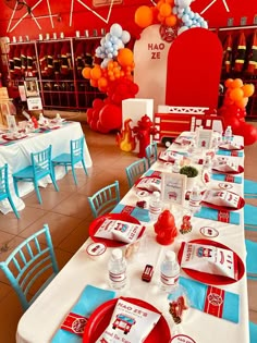 a table set up with red, white and blue place settings for a fireman birthday party