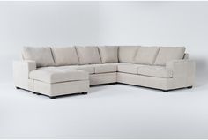 a white sectional couch sitting on top of a white floor