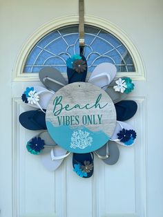 a sign that says beach vibes only hangs on the front door